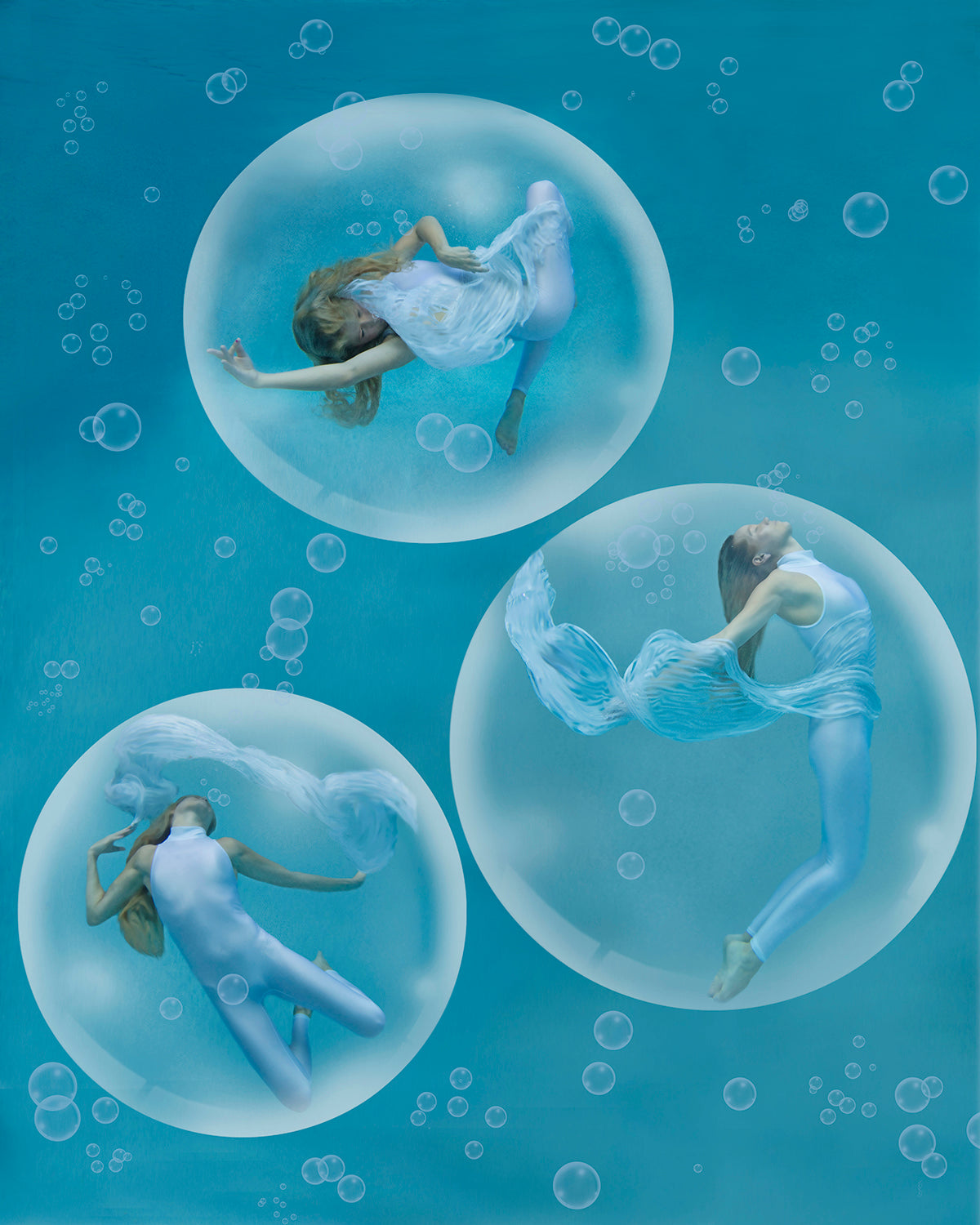 Three beautiful women positioned in elegant dancer poses while floating underwater in magical bubbles.