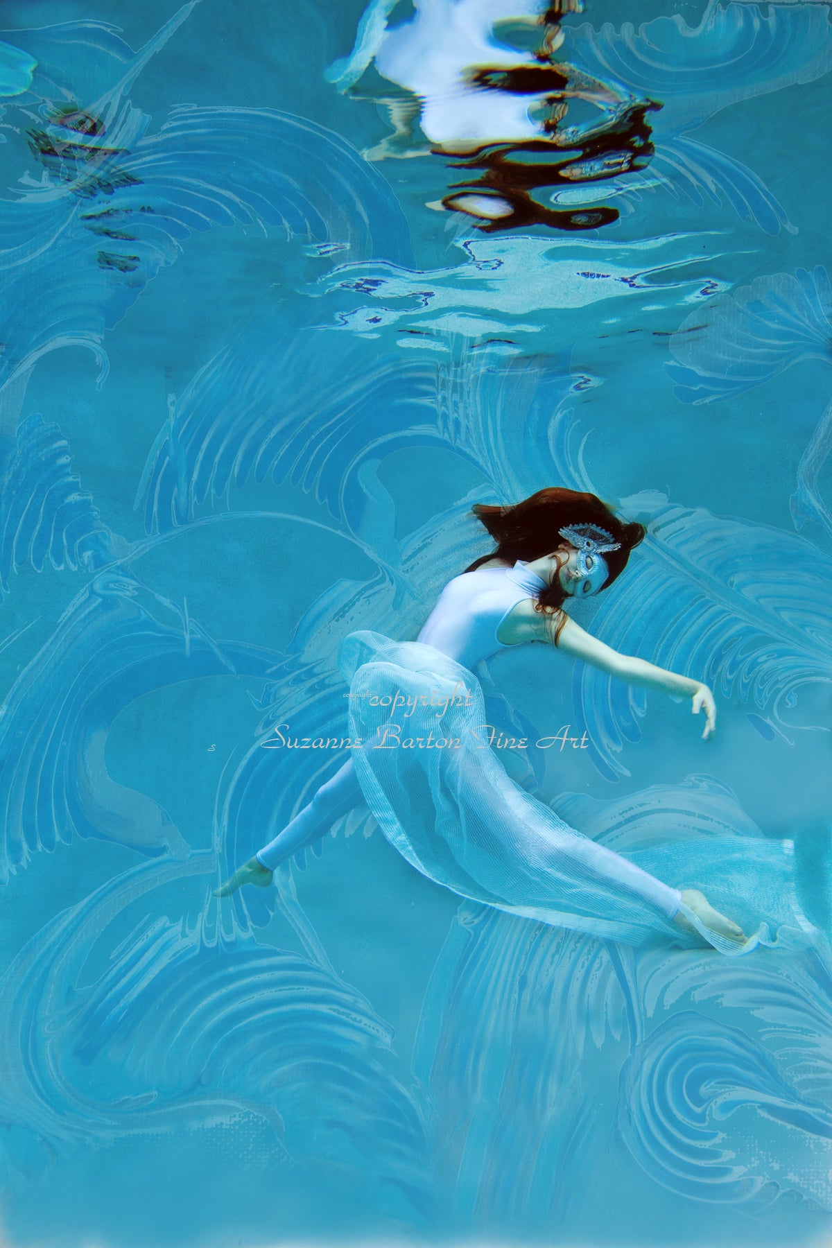 An ethereal image of a woman in a blue ballet skirt underwater surrounded by blue feather textures within the water.