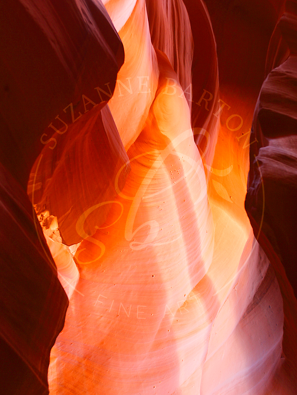 Antelope Canyon showing a spectacular spectrum of colors purple and orange. Sunlight filters through the narrow openings illuminating the canyon walls.