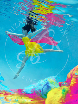 A mesmerizing image of a girl in a yellow dress with a floating bright pink scarf underwater set against a vividly colorful background, creating a stunning visual spectacle. 
