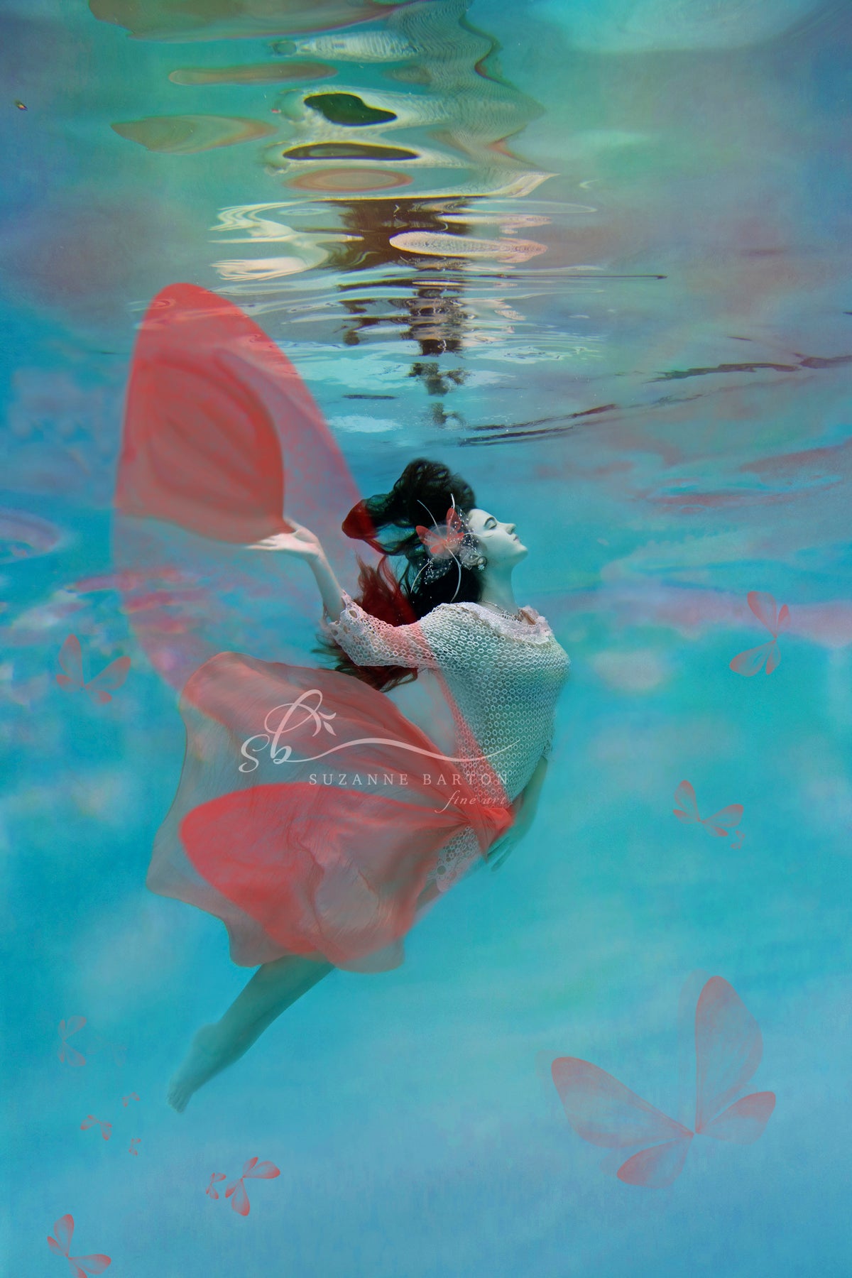 Dreamlike underwater portrait of a woman with delicate, wing-like elements, evoking a serene and dreamlike world